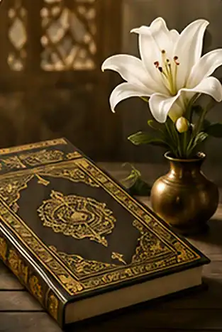 An ornate Quran and a white lily rest on a wooden table, representing Islamic Funeral Services New York.